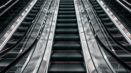 Obraz premium Close up of modern escalator stairs with metallic reflections and symmetry, Futuristic moving escalator steps with chrome surfaces and geometric perspective