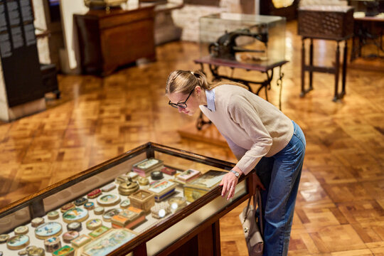 visitor in historical museum looking at art object