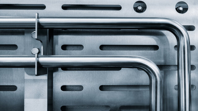 Metal stainless steel pipes as part of industrial hydraulic machine, high tech industrial background