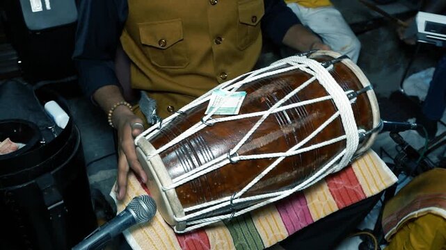 Indian Man Playing Dholak Drum at Wedding Celebration