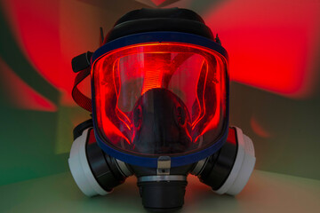 Exterminator&rsquo;s face mask with its filters, set in a colorful environment with colored lighting.
