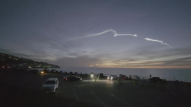 Ocean view rocket launch flying over the city