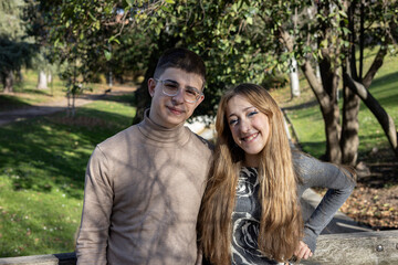 Fototapeta premium Young couple smiling together in park at autumn