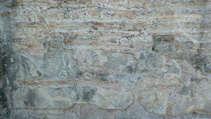 Obraz premium Stone wall background with ancient stonework. Close-up of a dilapidated stone wall