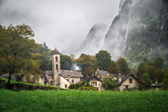 Cinematic mist drifts over Foroglio&rsquo;s stone rustici in Valle Bavona, Ticino, Switzerland, ideal for travel campaigns.