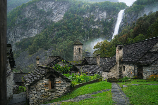 Cinematic mist drifts over Foroglio&rsquo;s stone rustici in Valle Bavona, Ticino, Switzerland, ideal for travel campaigns.