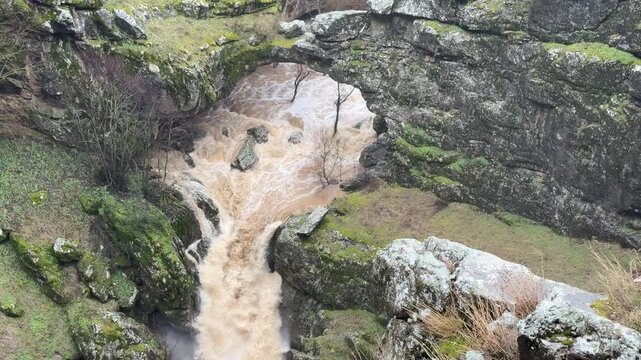 Muddy Stormwater Rushing Into Karst Sinkhole Following Extreme Rain