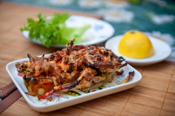 Baked Casserole of Broccoli with Chicken, Potato, Sweet Bell Red Pepper, Tomatoes and Cheese on Plate on Kitchen Table. Selective Focus.