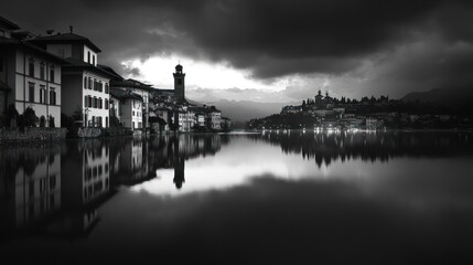 Black and white Italian lake town reflected in water, dramatic sky