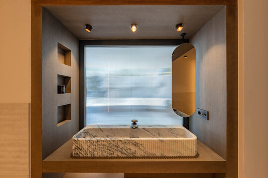 an image of a luxury wooden framed vanity mirror with marble stone sink in mediterranean villa 