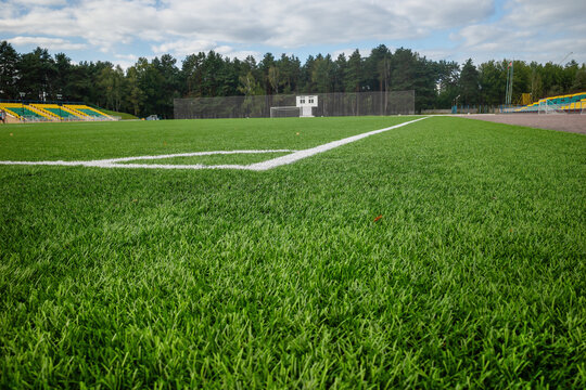 Close up of green artificial grass on empty football stadium