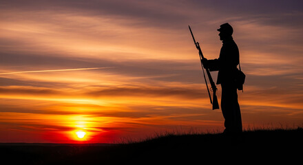Silhouette of a Civil War soldier with rifle at sunset on a hill