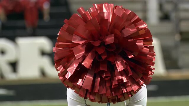 A collection of vibrant red spherical decorative ornaments adorning a pristine white athletic garment