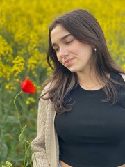 Naklejka premium Teen Girl Standing in Yellow Flower Field in Spring