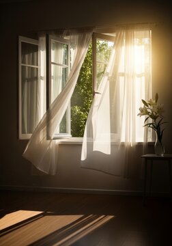 Open window with white sheer curtains fluttering in a gentle breeze with sunlight streaming in. Soft home interior and freshness concept.