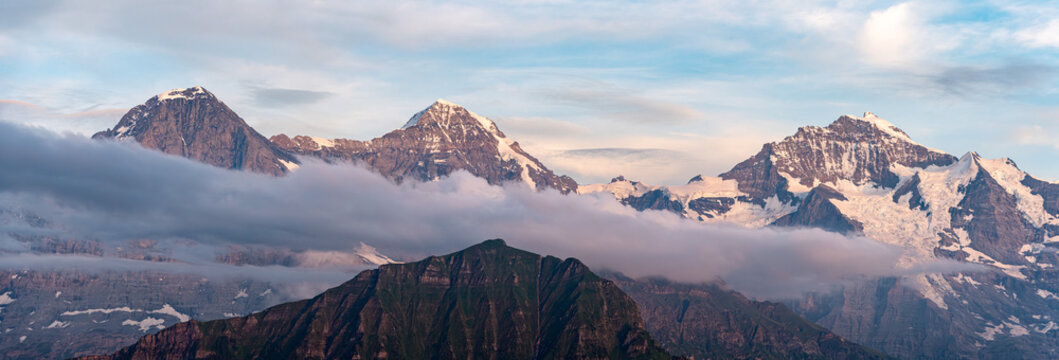 Famous mounts Eiger, Moench and Jungfrau in the Swiss alps, mount Maennlichen in the foreground