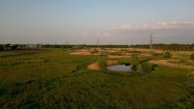 Aerial drone flying over a dutch polder landscape at sunset