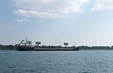 Obraz premium River Freight Transportation with Cargo Ship
