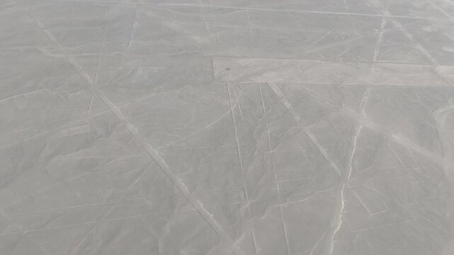 Nazca, Peru - 5 December 2025. View from a light aircraft of geometric Nazca lines carved into the desert surface, forming long straight tracks across the arid plain.