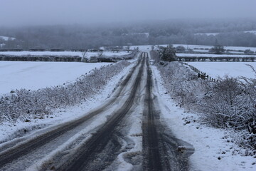 Snow covered countryside road in winter
