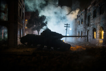 Obraz premium War Concept. Military silhouettes fighting scene on war fog sky background, World War Soldiers Silhouette Below Cloudy Skyline At night. Battle in ruined city.