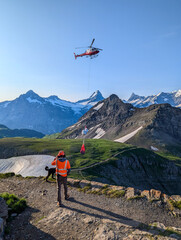 Faulhorn, Switzerland - August 13, 2025 - A helicopter bringing the daily goods to a mountain hotel in the Swiss alps © imagoDens