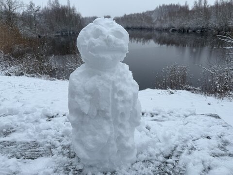 A beautiful handmade snowman standing in a snowy meadow in Doetinchem, Netherlands