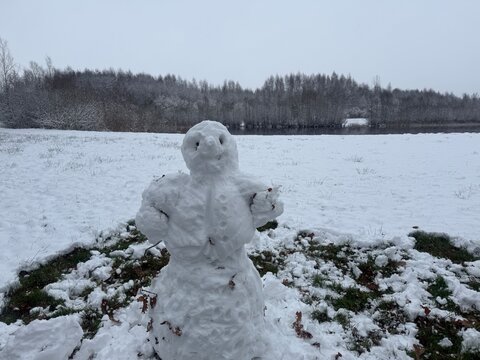 A beautiful handmade snowman standing in a snowy meadow in Doetinchem, Netherlands