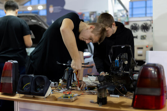 Engineering students assembling electronic components in workshop