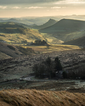 Aerial view of the undulating hills and valleys, with the distinctive peak of Chrome Hill visible in the distance, Peak District National Park, United Kingdom.