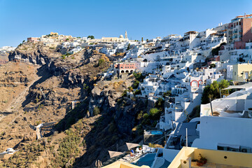 Santorini's white houses cascade down the volcanic cliff.