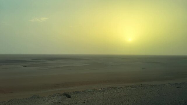 Drive along panoramic view of a serene sunrise over the vast expanse of the Sahara Desert