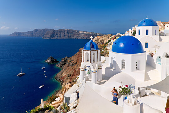 Picturesque Santorini: blue domes, white buildings, and caldera views.