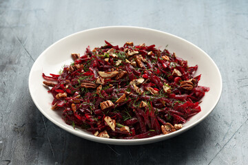 Raw beetroot salad garnished with dill and pecan nuts. Healthy salad, Heaghy in fibre