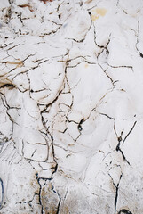 Natural white mineral rock texture with cracks, abstract geological background
