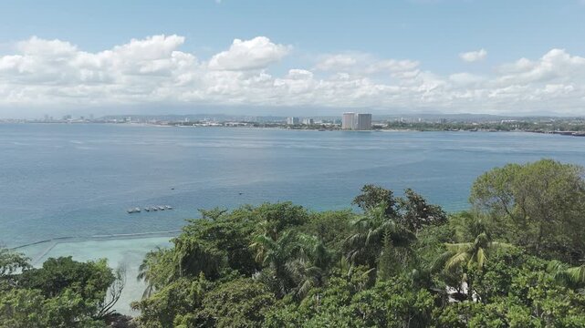 Aerial View of Tropical Coastline with Davao City Skyline in the Distance, Philippines