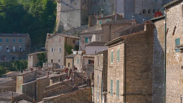 Sorano ancient italian town on tuff cliff. Picturesque view of the medieval town of sorano, an ancient village on a tuff cliff with old stone houses and characteristic terracotta roofs in the heart