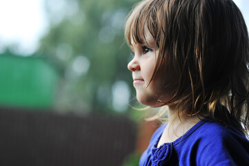 Side profile portrait of little girl outdoors in natural light with copy space for text © Olena Zelena