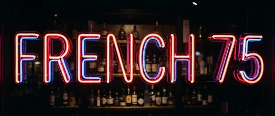 Fototapete Bar Glowing neon sign French 75 in dark cocktail bar  © DavoeAnimation