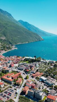 Torbole townscape from above with Lake Garda shoreline and mountain terrain