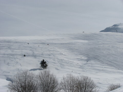 Soft white snow texture on mountain slope