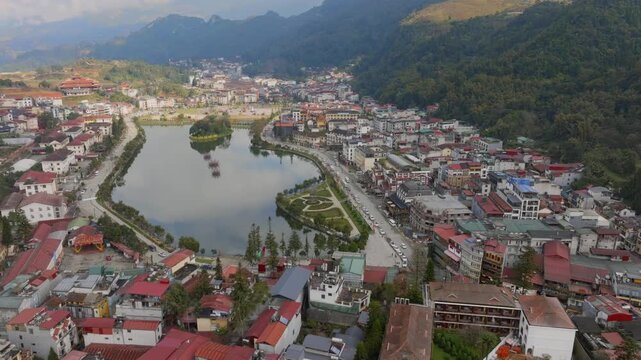 Aerial view of the town of Sa Pa, Vietnam, showcasing the architecture and natural beauty. Tourists visit to experience the culture and scenery of the region.