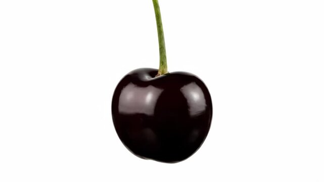 A single dark sweet cherry with a green stem presented in a sequence. Ripe berry rotating for healthy eating concepts, organic food marketing, or product advertising