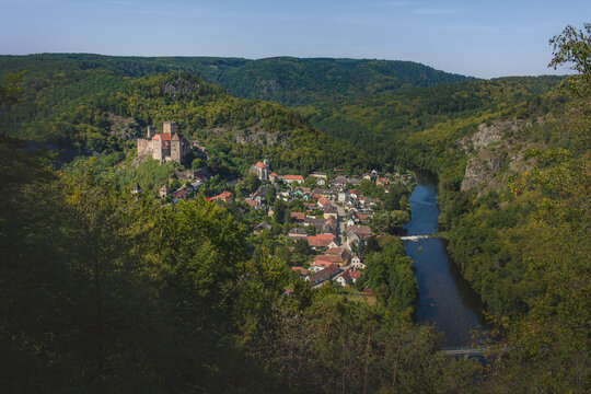 High-angle panoramic view of the town of Hardegg with its medieval castle and the Thaya river valley surrounded by deep forests of the National Park.