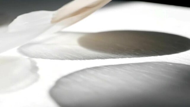 Finger Dipping into White Powder Closeup.