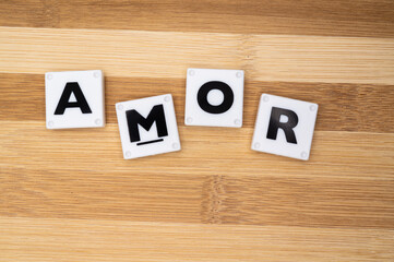 love word in language Spanish, collage of isolated text in vintage letterpress wood type printing blocks,