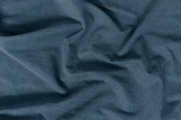 Fototapeta premium Detailed texture of a corduroy fabric background. Top view of a rich blue, navy, denim, slate tone textile material softly draped to create an abstract background