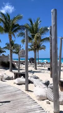 Cinematic 4K Vertical POV of a luxury beach club with palm trees and turquoise water in Bimini Bahamas