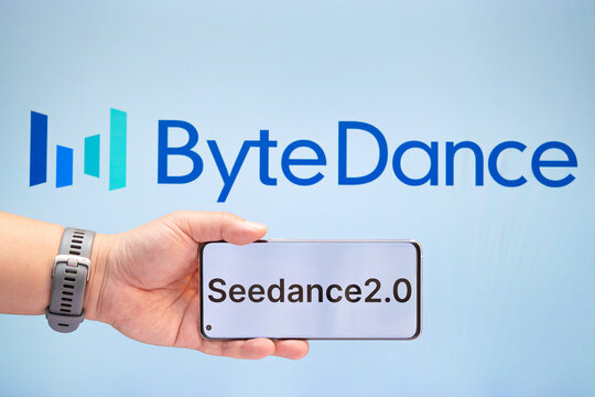 ZHONGSHAN China-February 15 2026: man holding a mobile with Seedance 2.0 in front of ByteDance logo at horizontal composition.