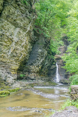 A waterfall is flowing down a rocky cliff